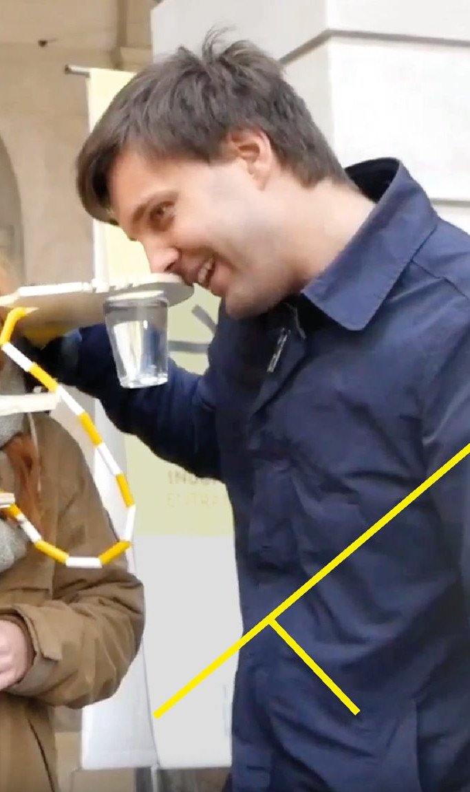 four people touching neighborhood paddles to their noses